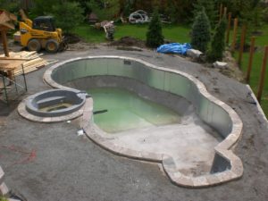 Backyard swimming pool with pool coping installed