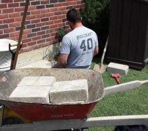 A Pool Craft team member working on the landscaping at a residential property