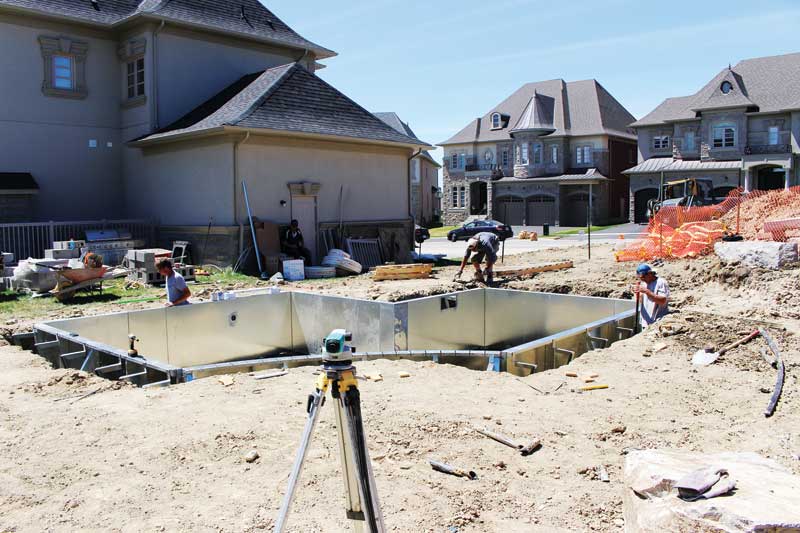 The Pool Craft team installing a small custom backyard swimming pool