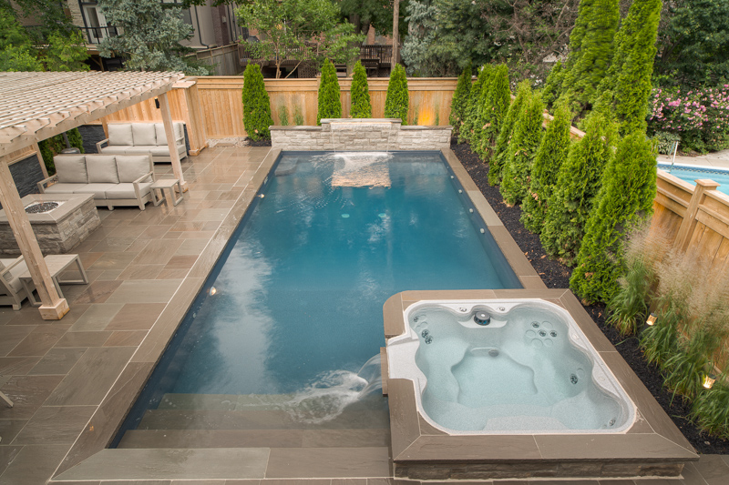 A backyard swimming pool with custom landscaping