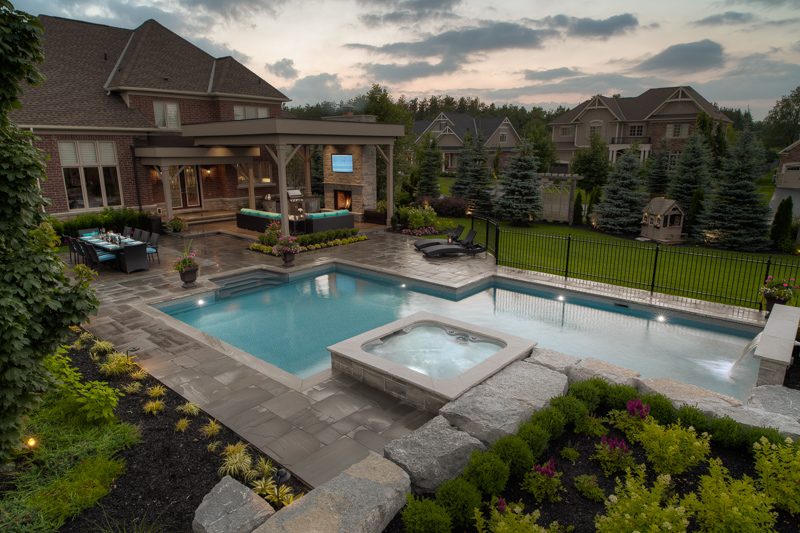 A custom shape backyard pool with spa