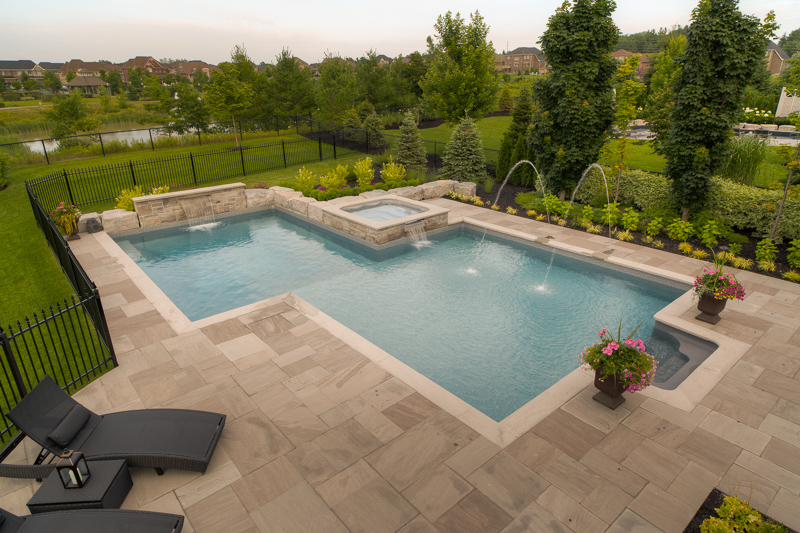 Backyard swimming pool with water jets feature